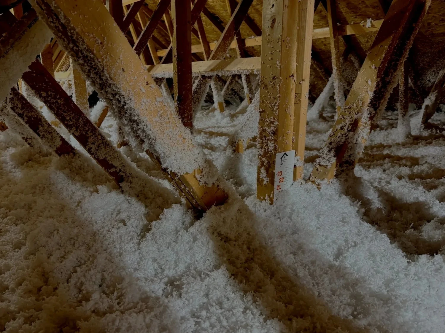 Low attic corner with new loose fill between the trusses