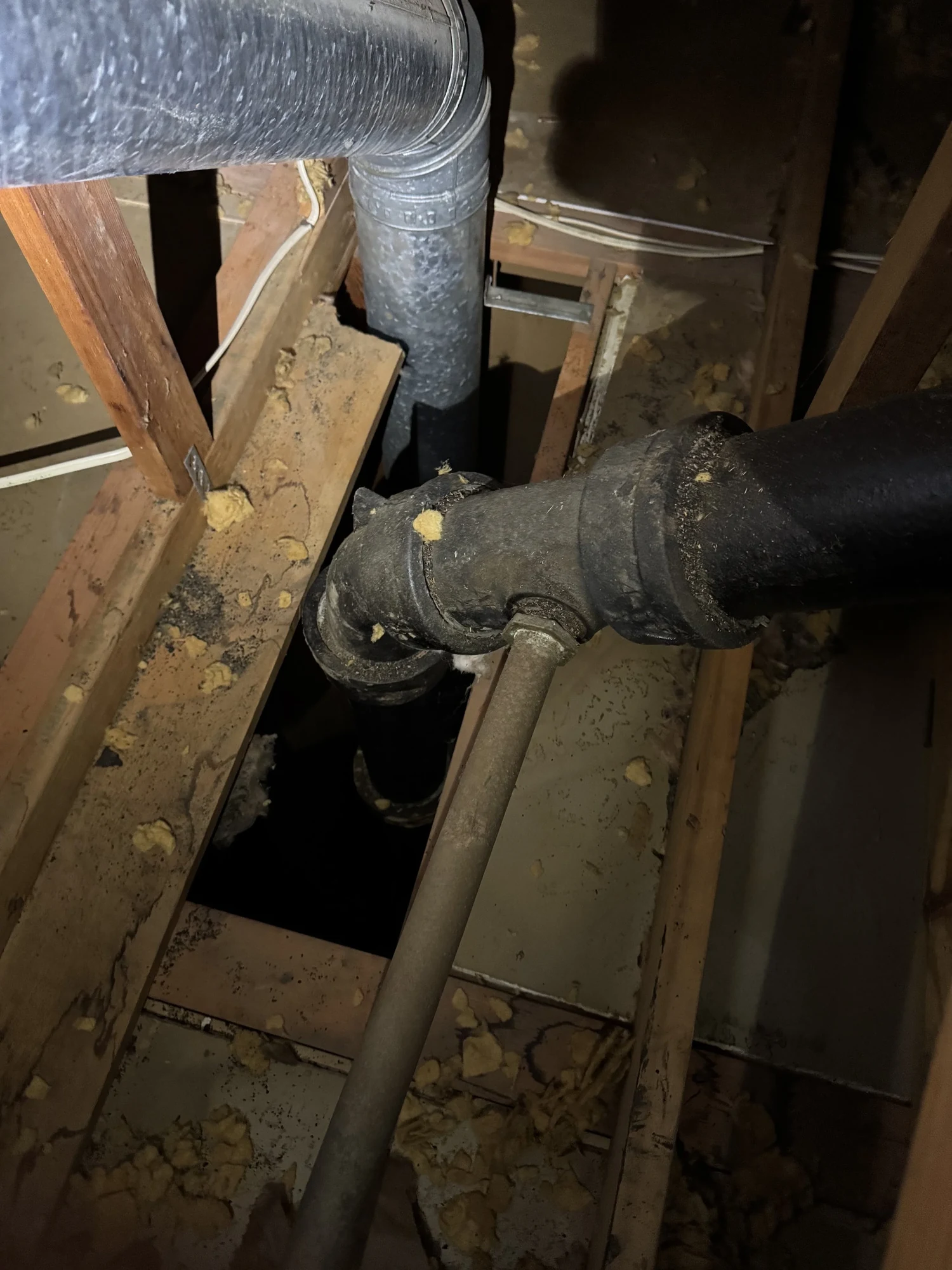 Open chase in an attic floor around duct and vent pipes, where open ventilation is being created