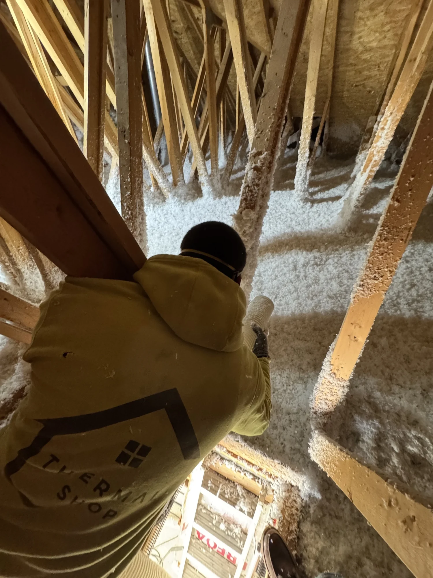 Thermal Shop installer at the attic access with new loose fill around the opening