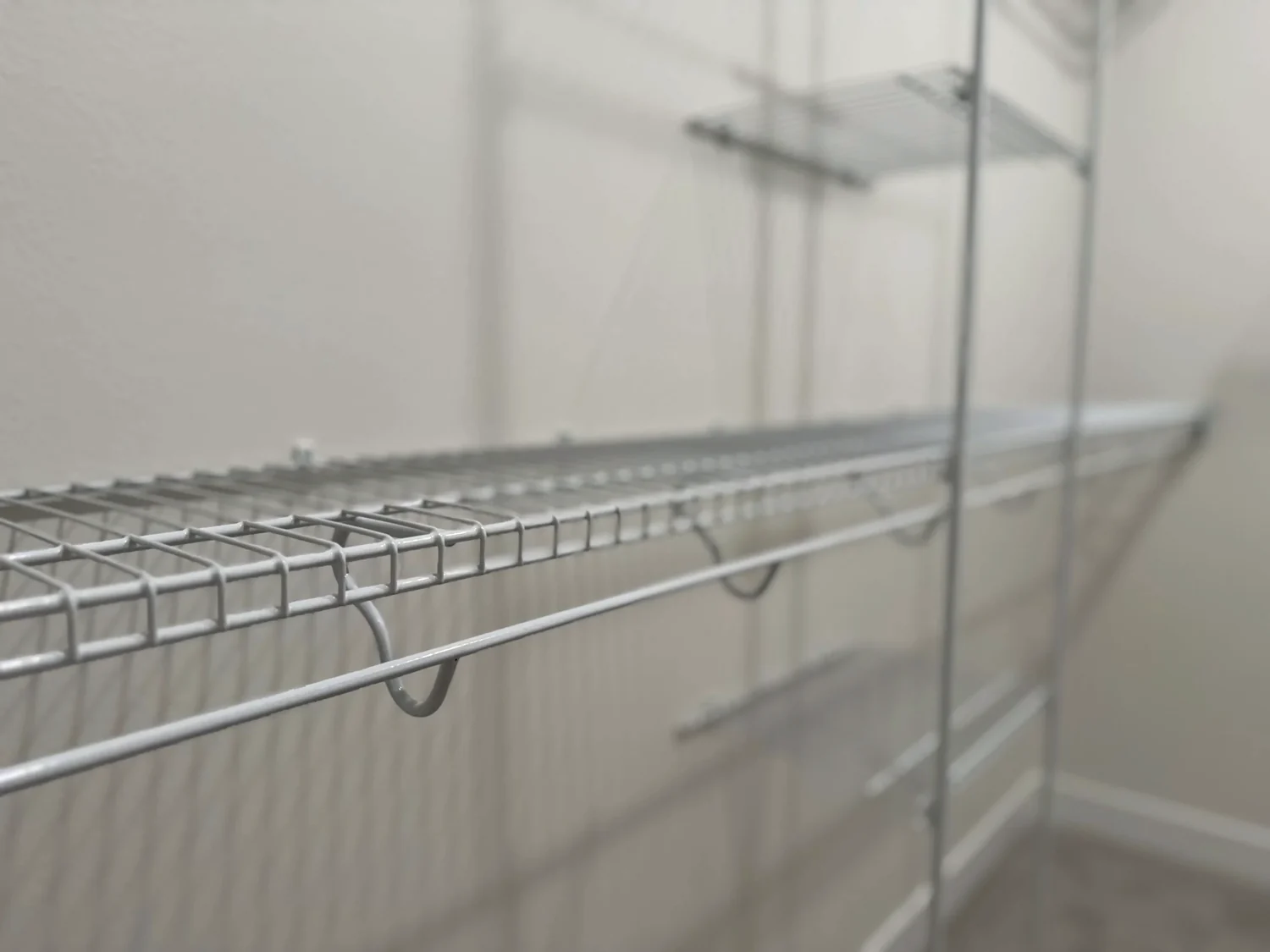 Close view of a wire shelf with a hanging rod beside a shelf tower