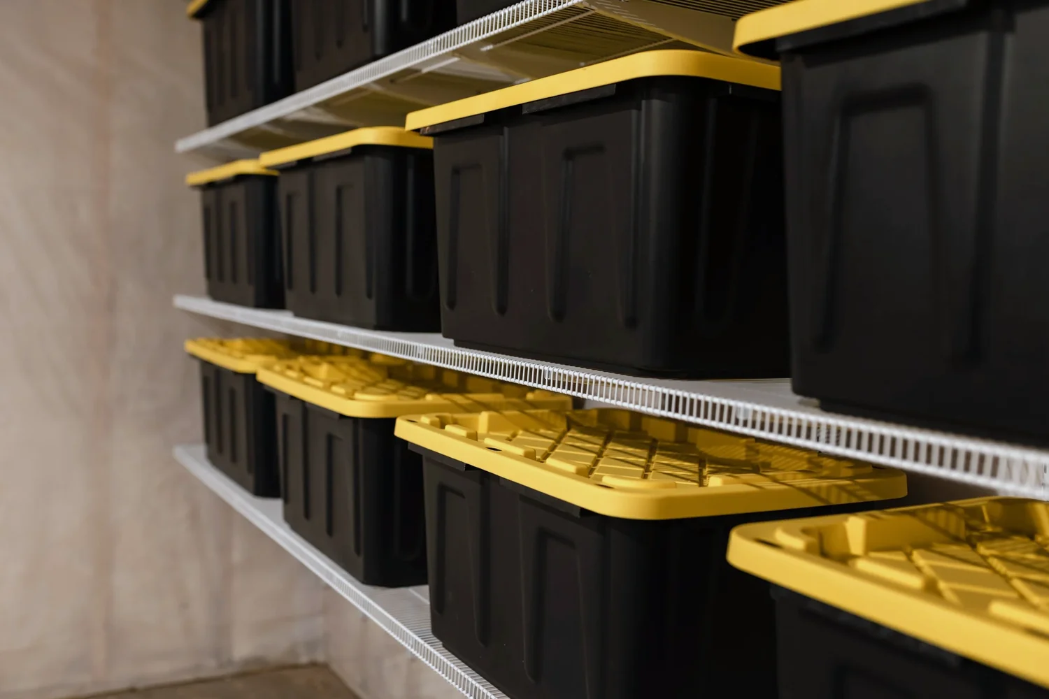 Close view of storage bins on a white wire shelf