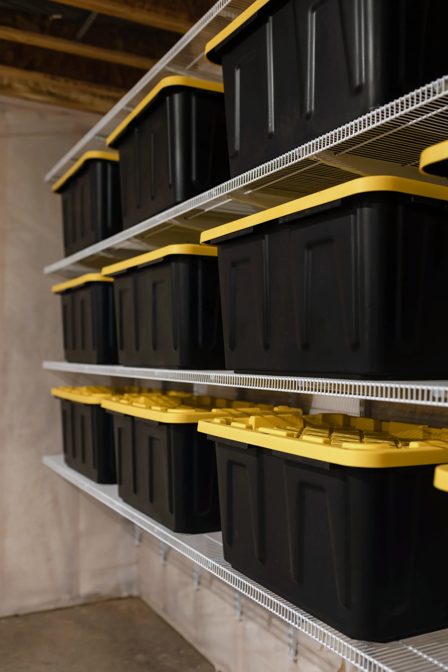 Angled view of storage bins stacked on white wire shelves