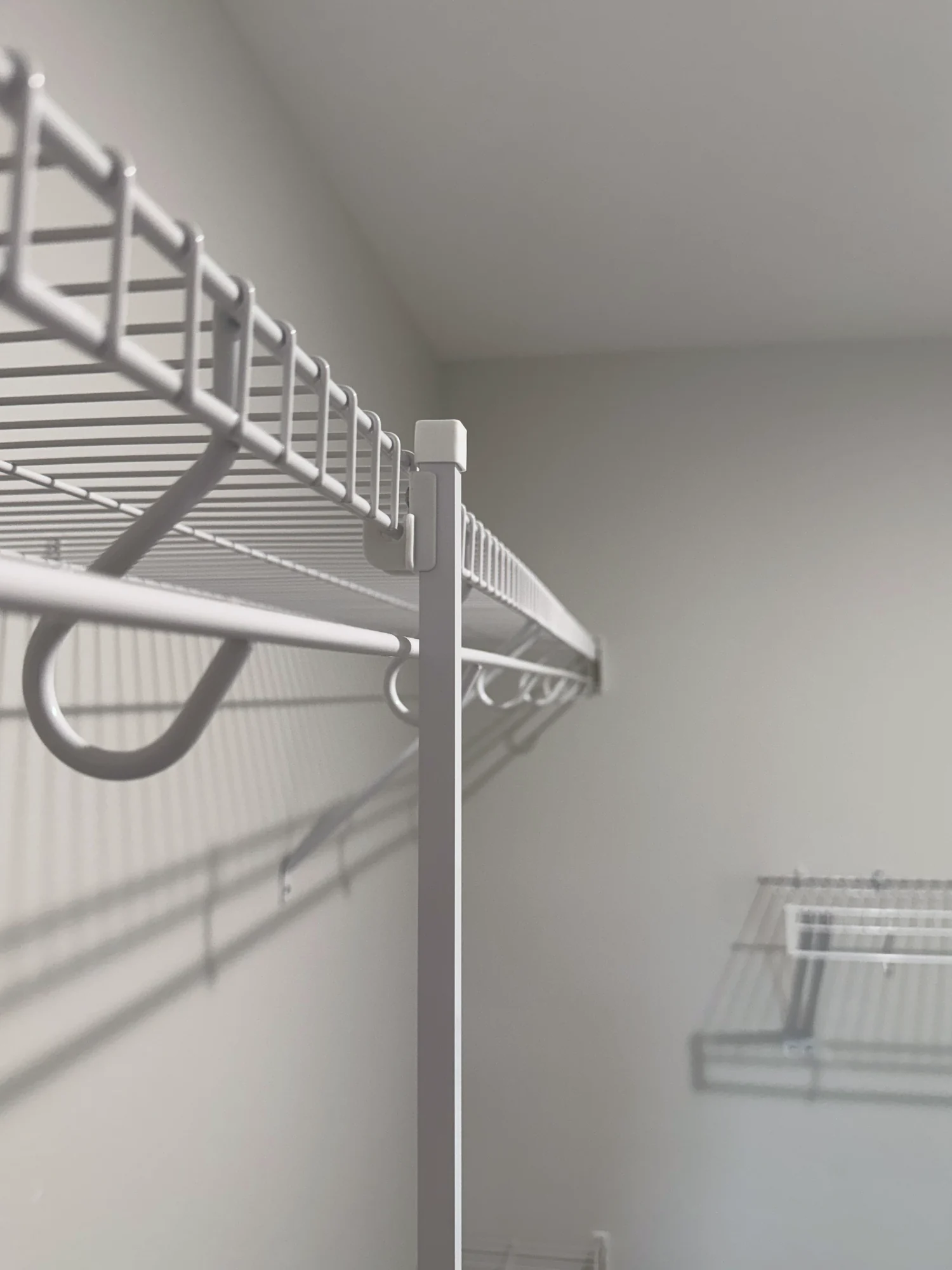 Close view of the end of a wire shelf and hanging rod at a support pole